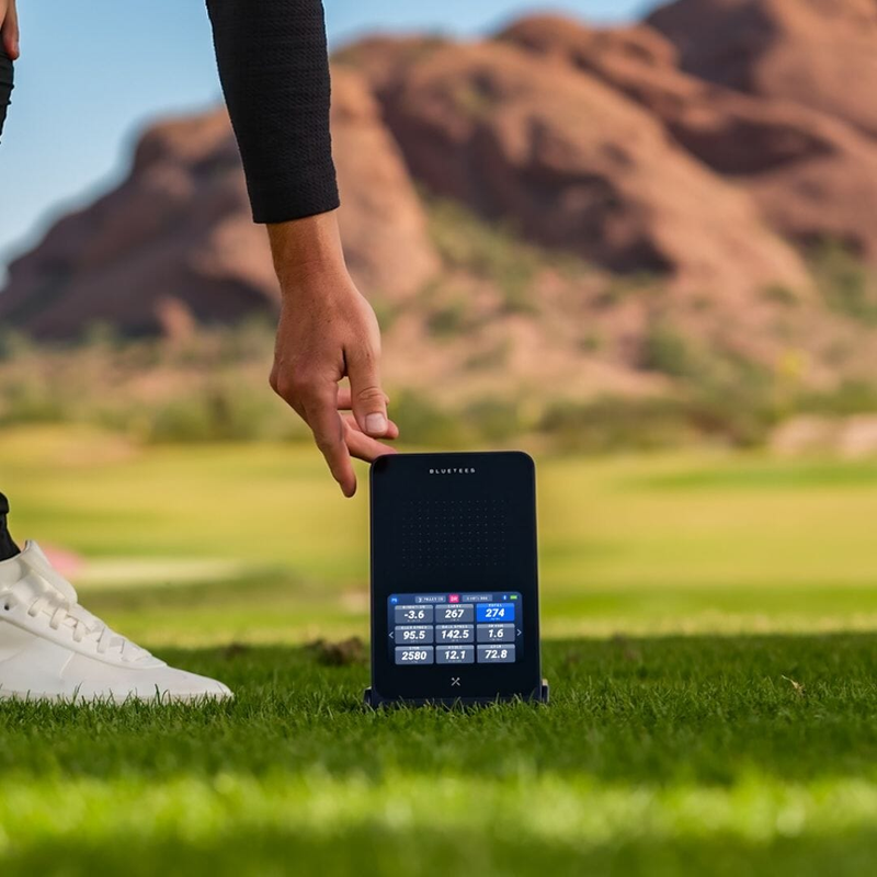 Blue Tees Rainmaker Launch Monitor on tee with full shot data.