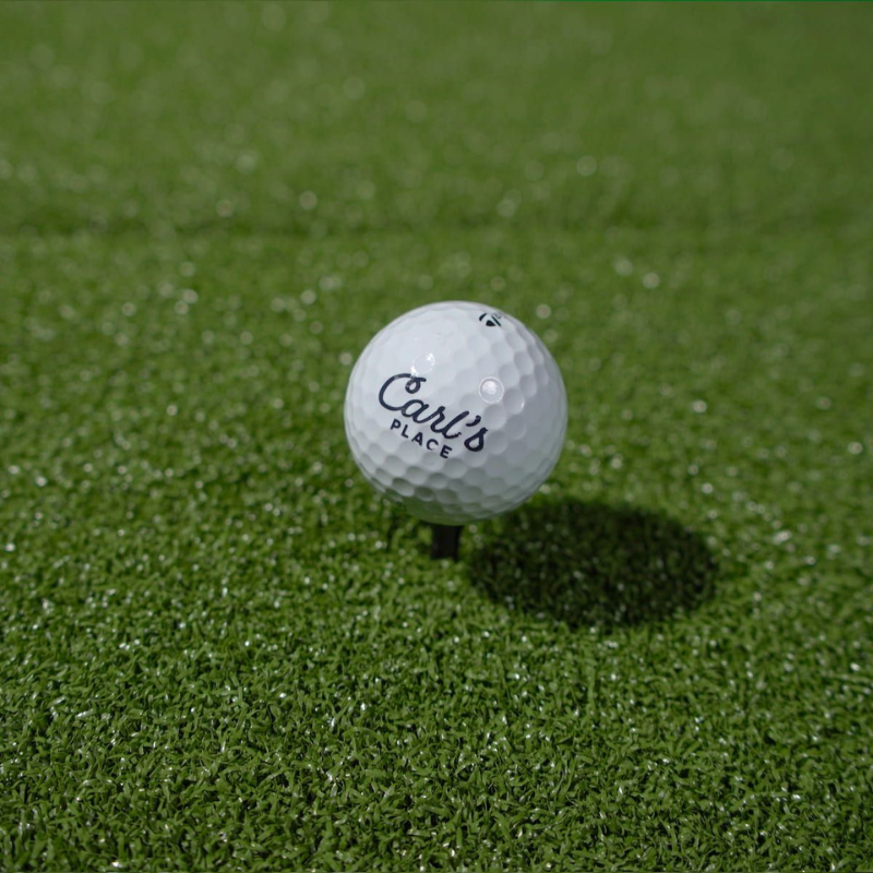 Carl's Place HotShot Golf Hitting Mat with ball and tee.