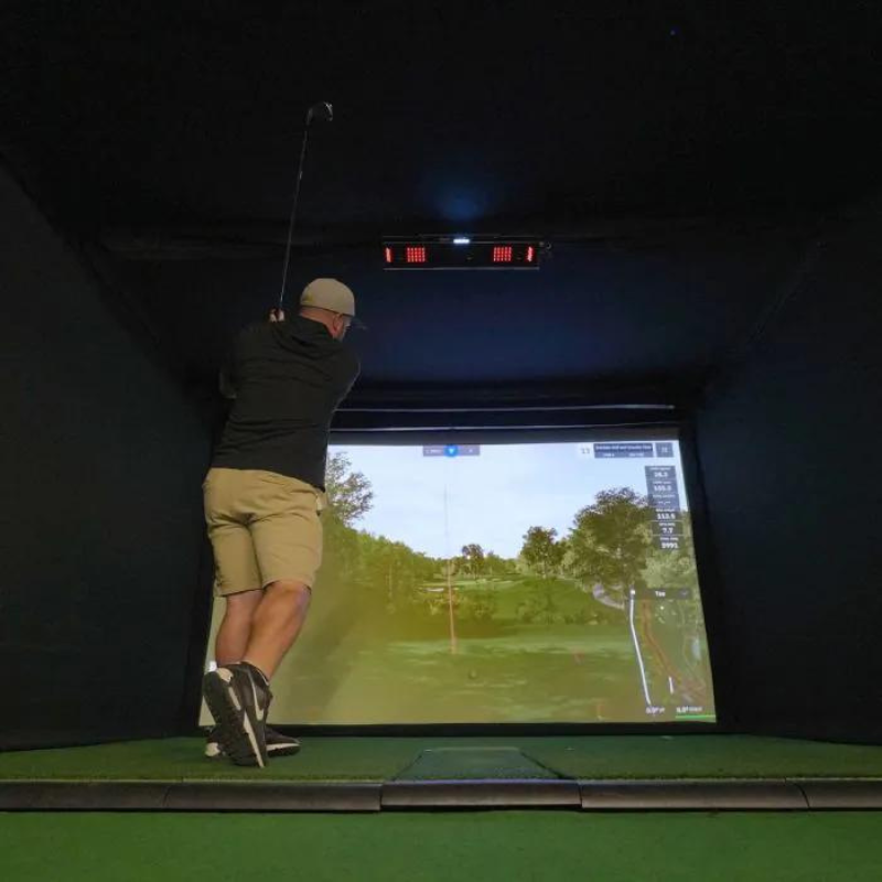 Carl's Place Uneekor EYE XO2 Protective Case installed in golf simulator with golfer swinging.