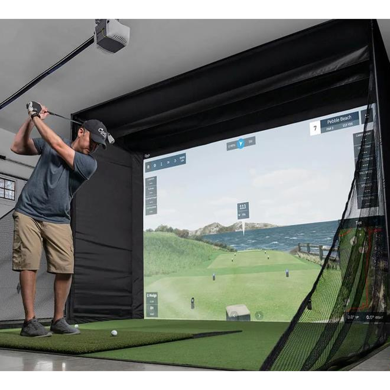 Impact Sports Triangular Net Barriers (Set of 2) in use in a garage golf simulator bay during a swing.