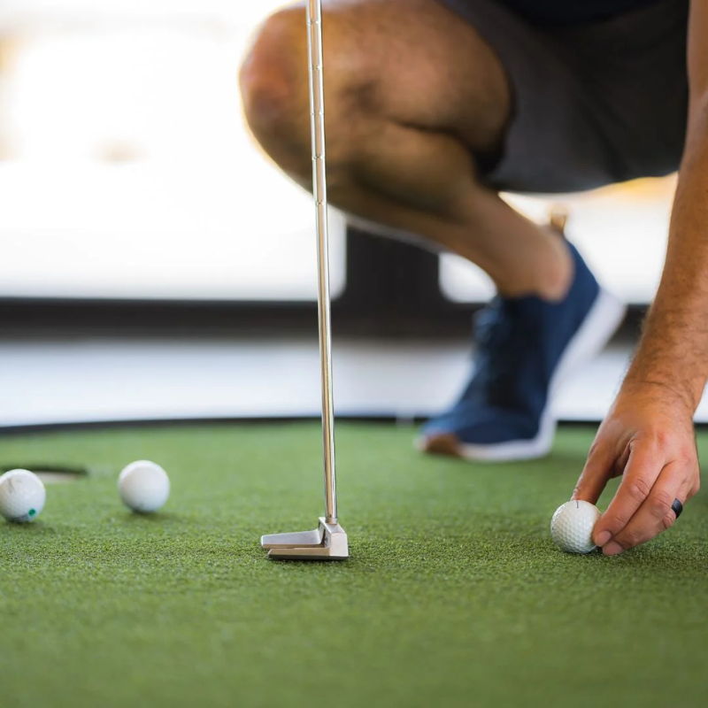Money Putt Golf Turf with golfer, golf ball, and putter.