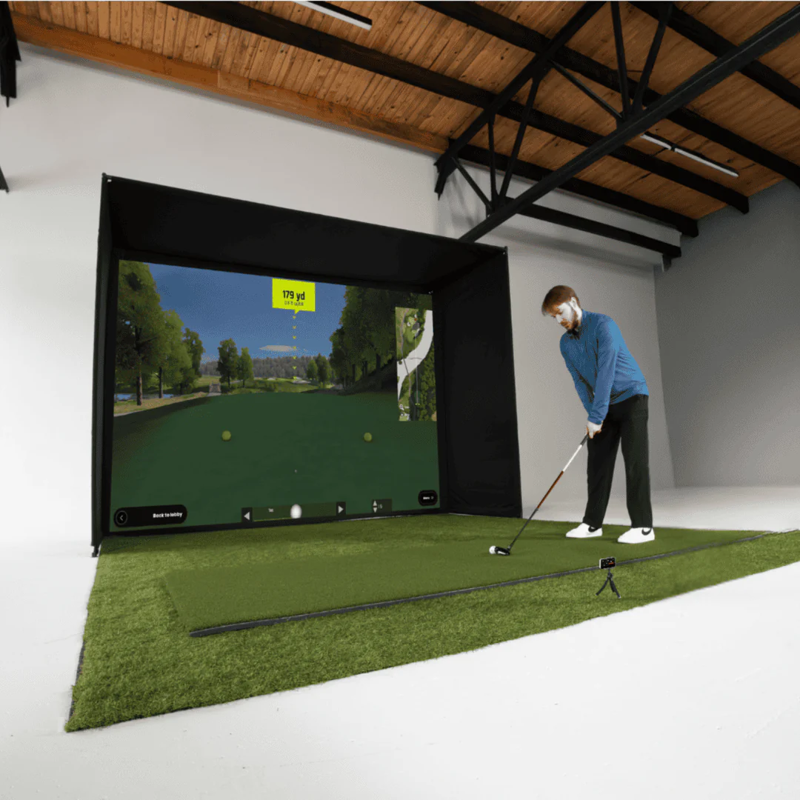 Red Stakes Golf Mobile Golf Studio Bundle indoor golf simulator man ready to swing at full screen display.
