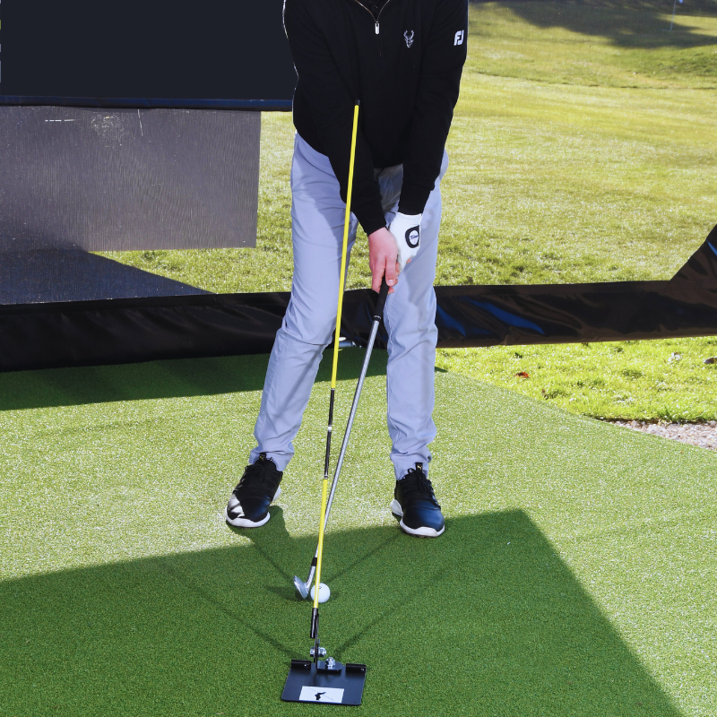 The Swing Plate Base with golfer in impact position caddie view.