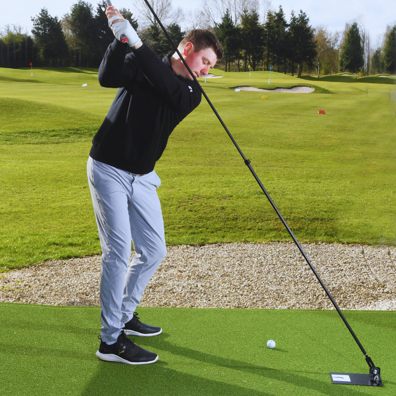 The Swing Plate Base with golfer at top of backswing.