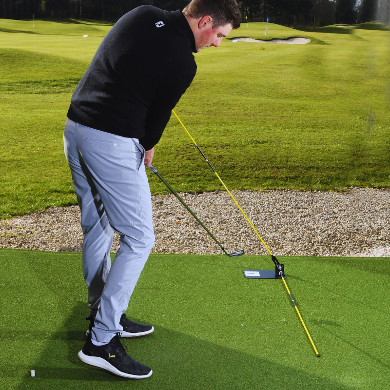 The Swing Plate Base with golfer post impact down the line view.