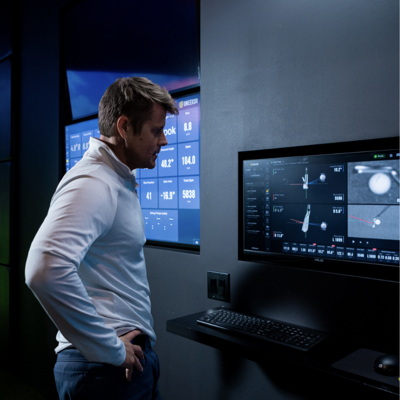 Uneekor EYE XR Launch Monitor person interacting with shot analysis software.