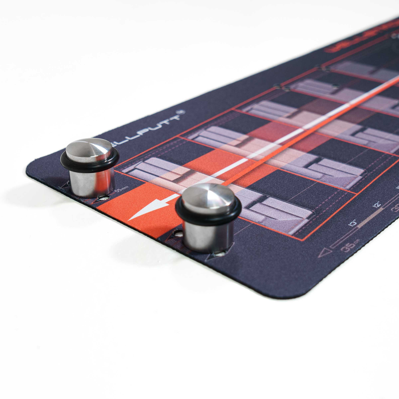 Gate drill weights placed on a putting mat.
