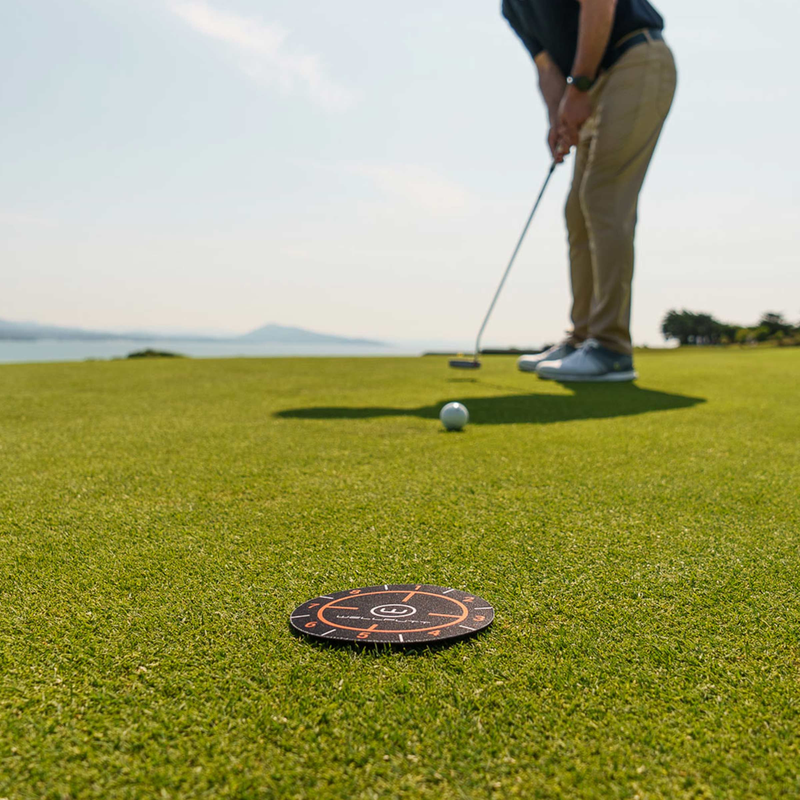 Ghost Hole target disc placed on a putting green.